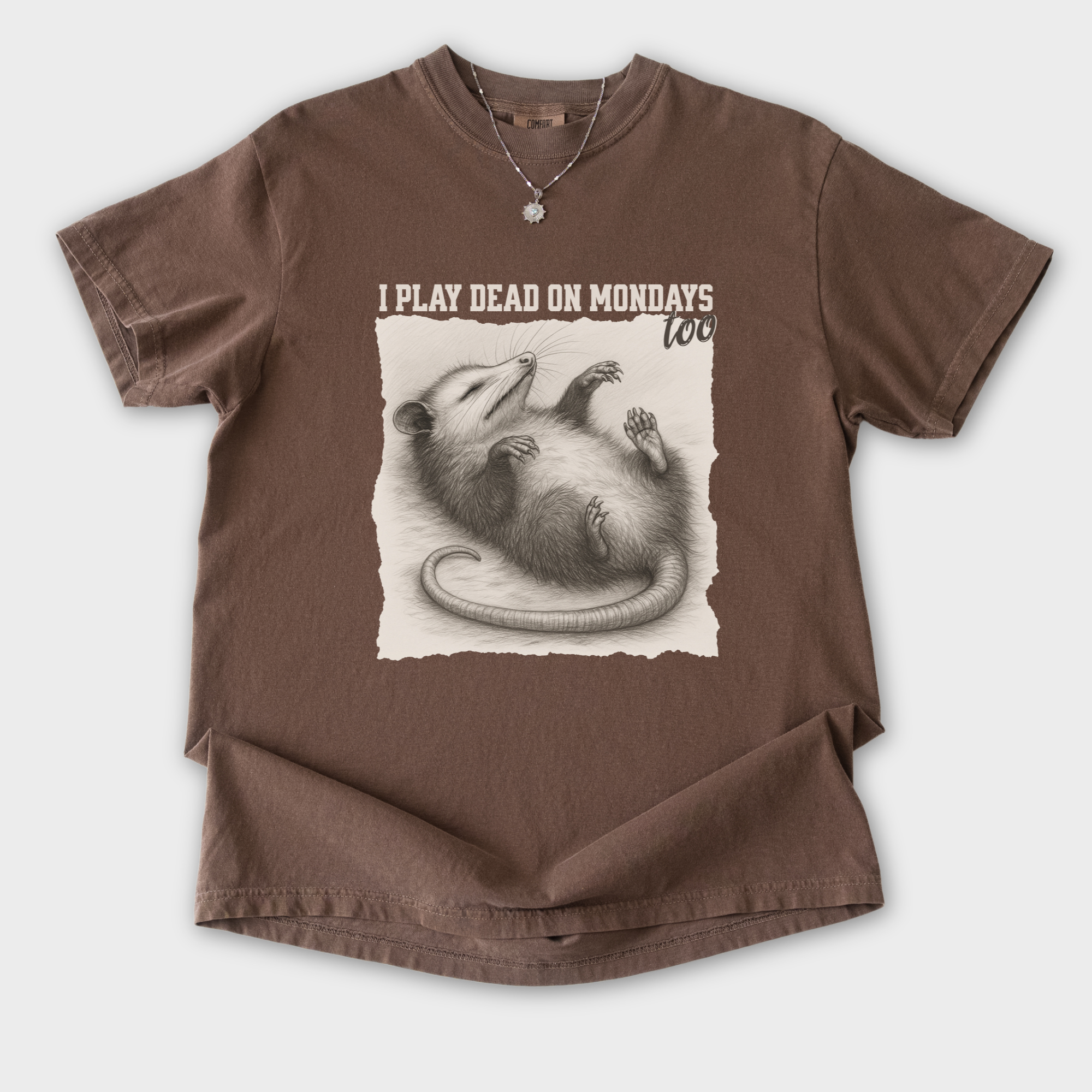western-i-play-dead-on-mondays-too-feral-line-art-comfort-colors-t-shirt-in-espresso - Espresso Flat Lay Front