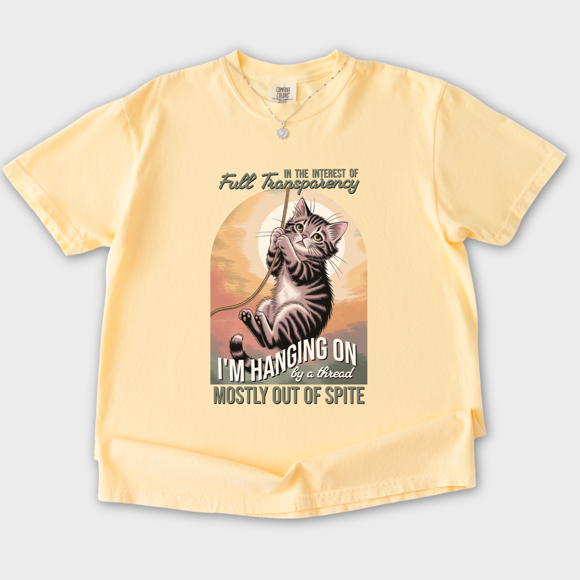 western-hanging-on-by-a-thread-cat-graphic-comfort-colors-t-shirt-in-butter - Butter Flat Lay Front