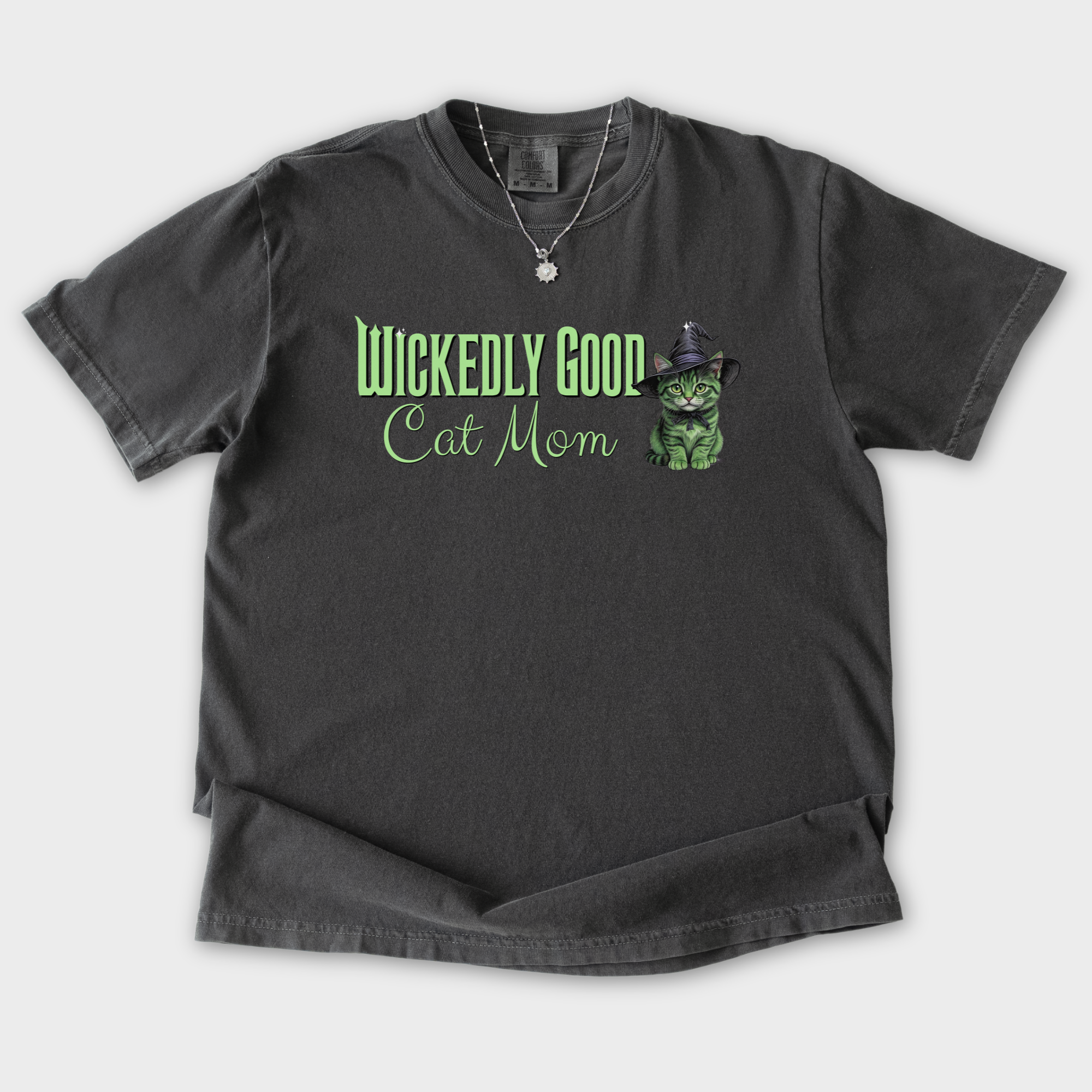 movie-inspired-green-wickedly-good-cat-mom-cat-graphic-comfort-colors-t-shirt-in-pepper - Pepper Flat Lay Front
