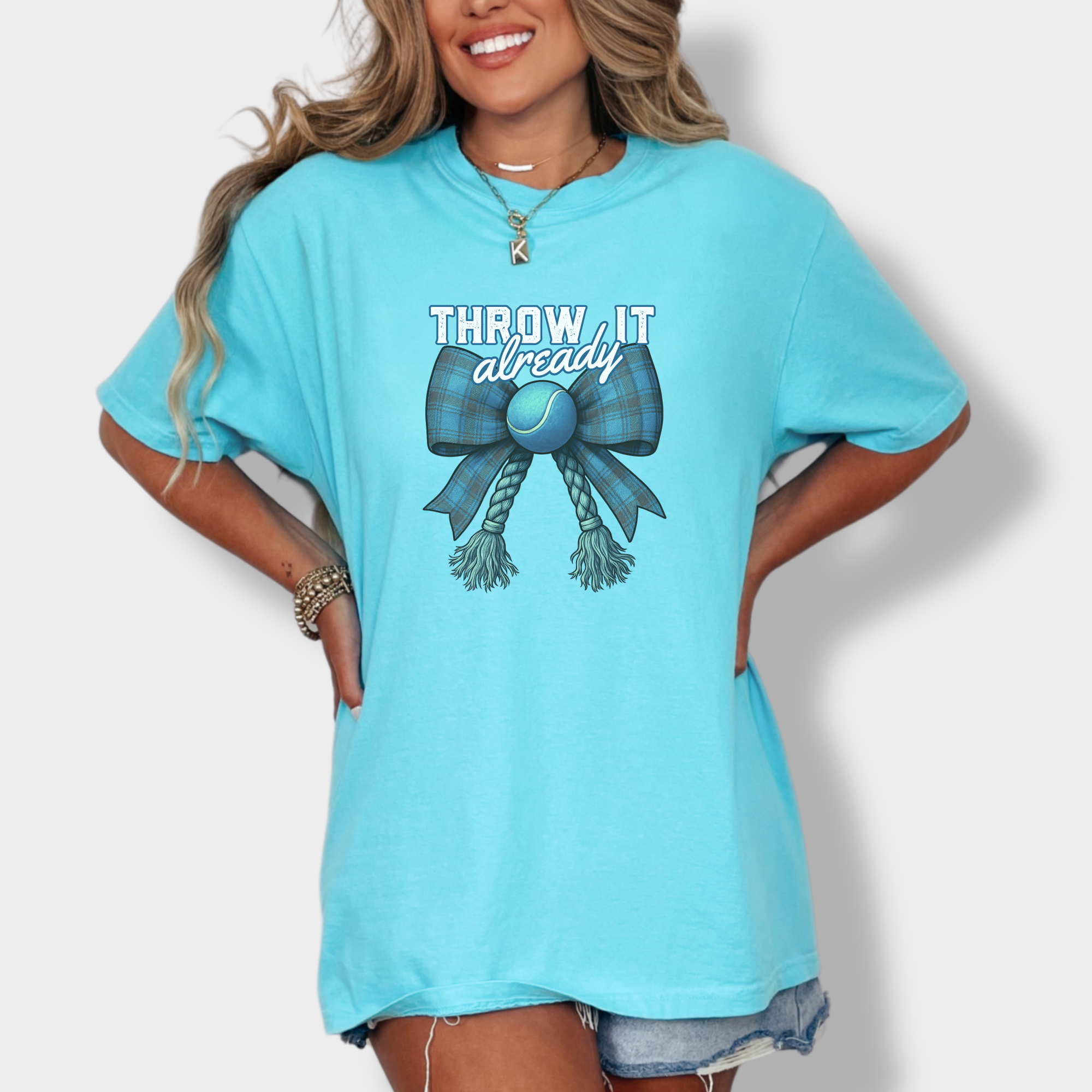 retro-throw-it-already-dog-chew-toy-bow-in-blue-dog-bow-comfort-colors-t-shirt-in-lagoon-blue - Lagoon Blue Lifestyle Female Model