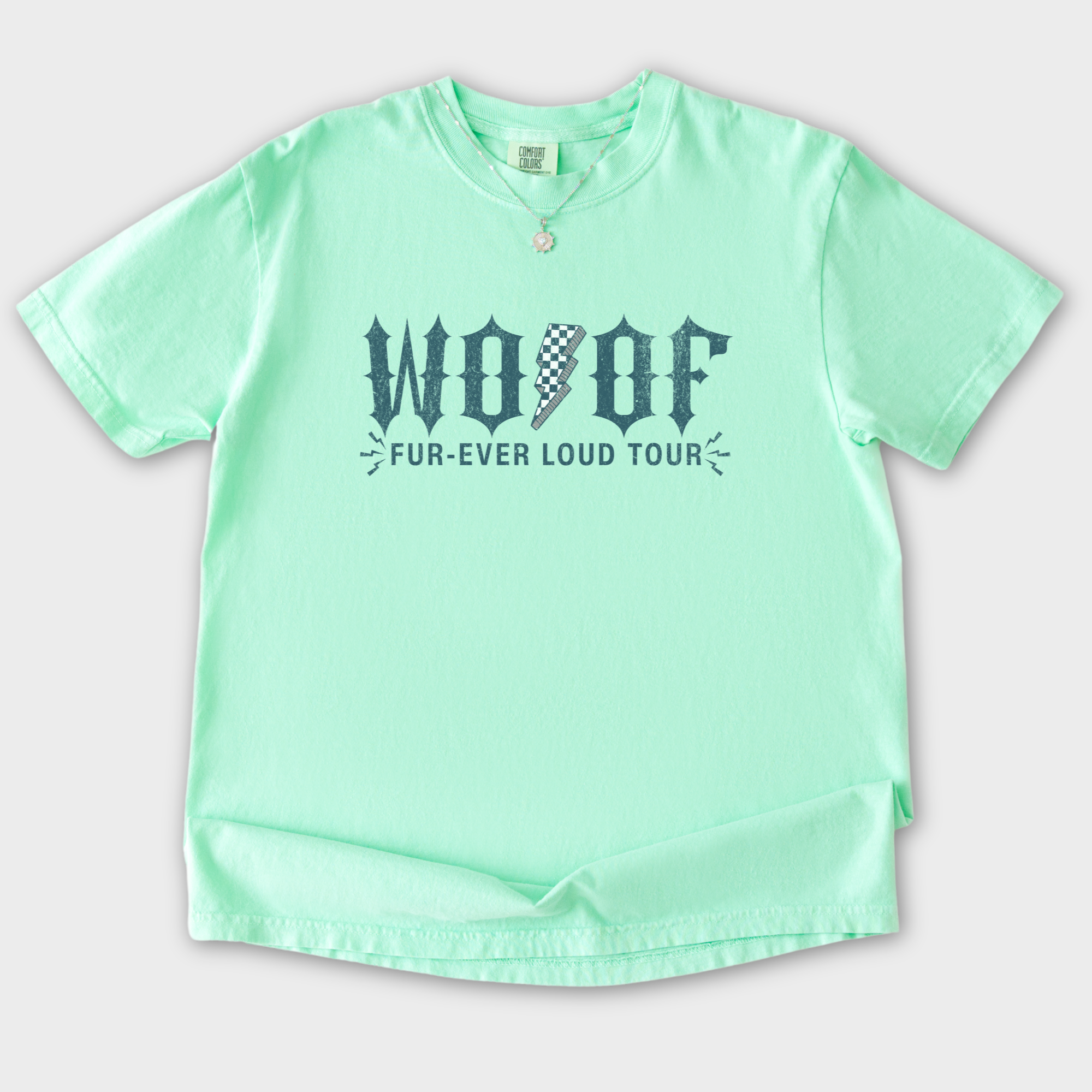 artistic-woof-furever-loud-tour-dog-graphic-comfort-colors-t-shirt-in-island-reef - Island Reef Flat Lay Front