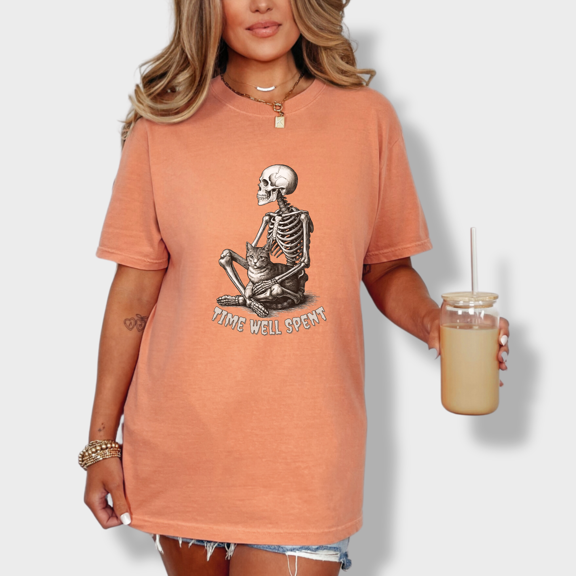 line-art-sit-still-skeleton-petting-cat-cat-skeleton-comfort-colors-t-shirt-in-terracotta - Terracotta Lifestyle Female Model