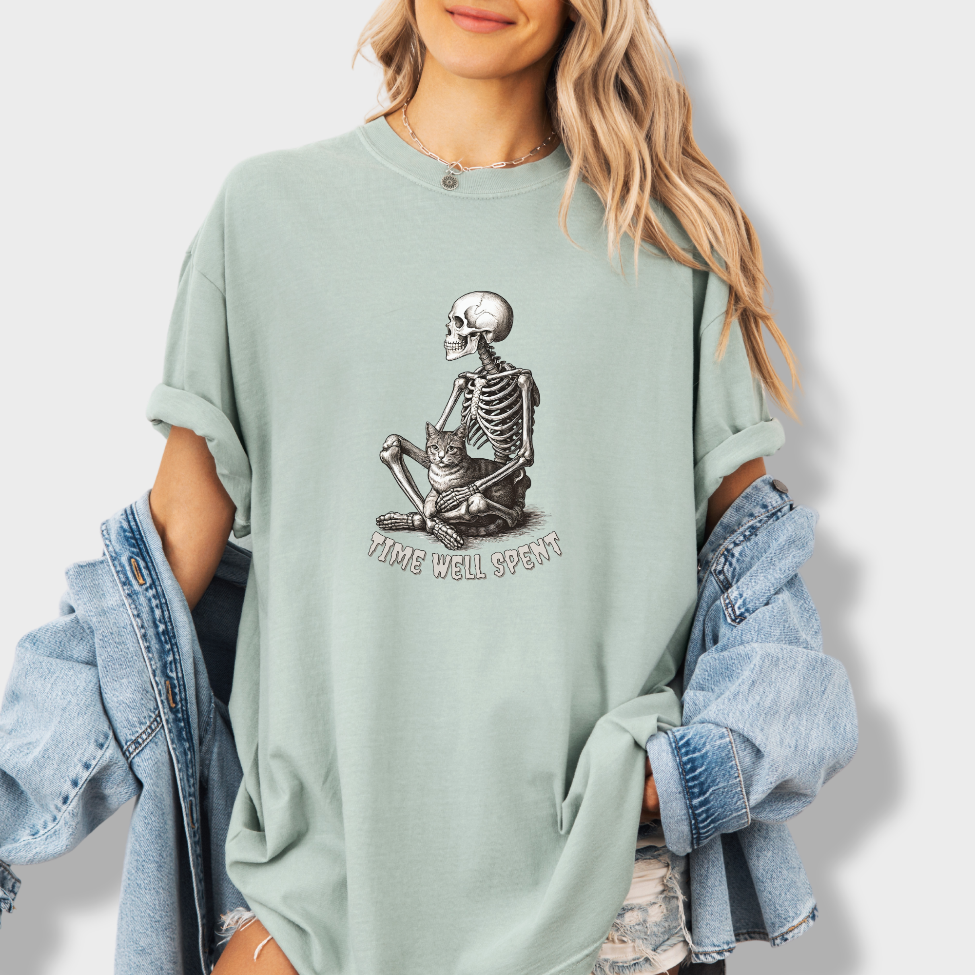 line-art-sit-still-skeleton-petting-cat-cat-skeleton-comfort-colors-t-shirt-in-granite - Granite Lifestyle Female Model