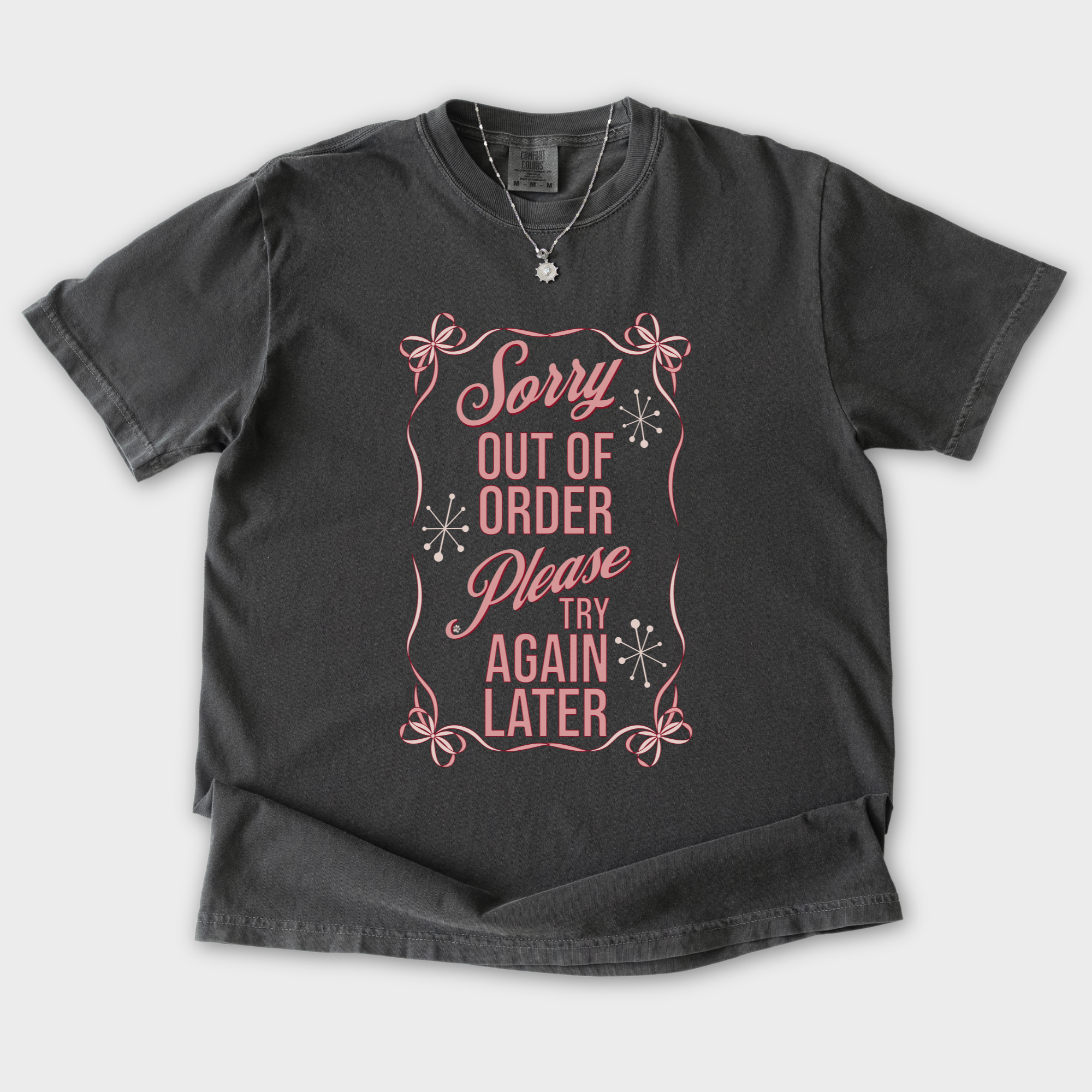 minimalist-sorry-out-of-order-please-try-again-later-feral-bow-comfort-colors-t-shirt-in-pepper - Pepper Flat Lay Front