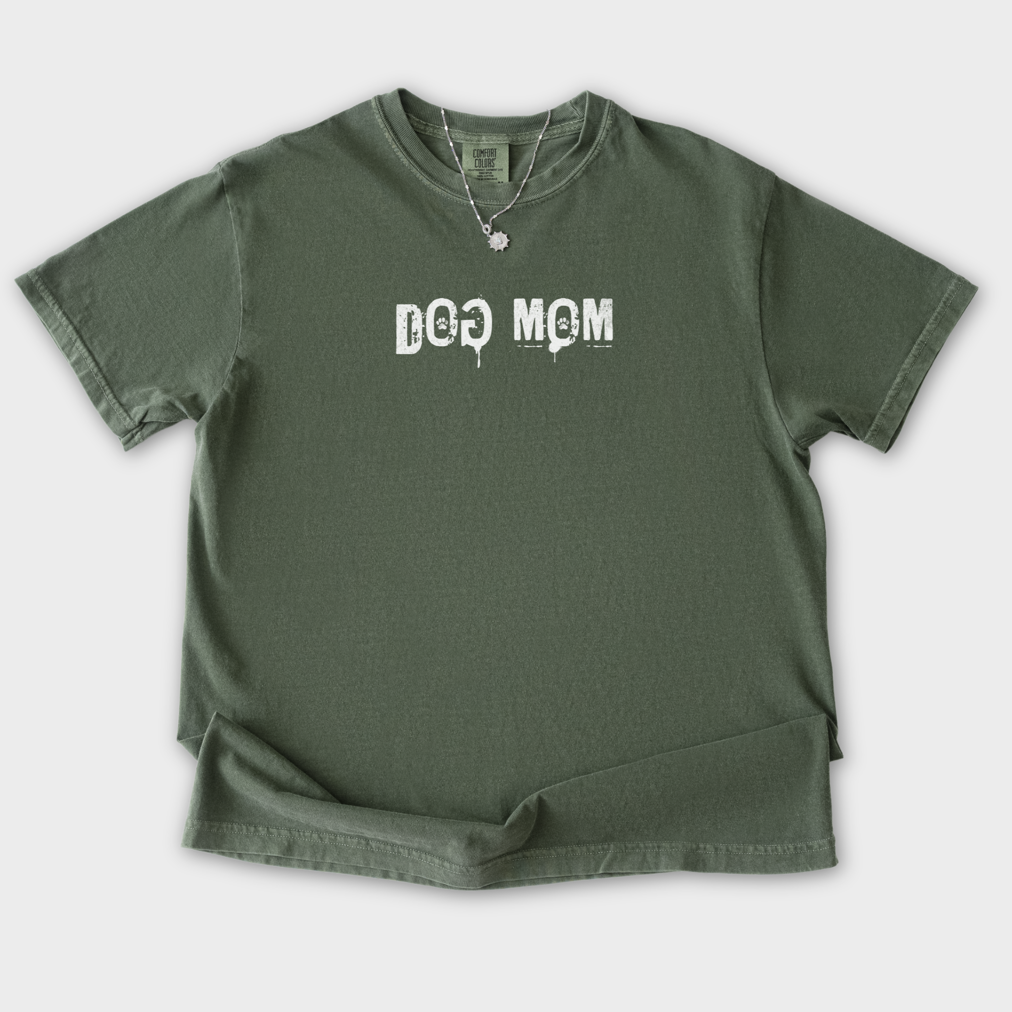 minimalist-dog-mom-messy-stamp-with-paint-splatter-dog-text-comfort-colors-t-shirt-in-moss - Moss Flat Lay Front